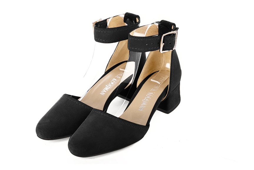 Women's matt black open side dress shoes, with a strap around the ankle. Round toe. Low flare heels - Front view